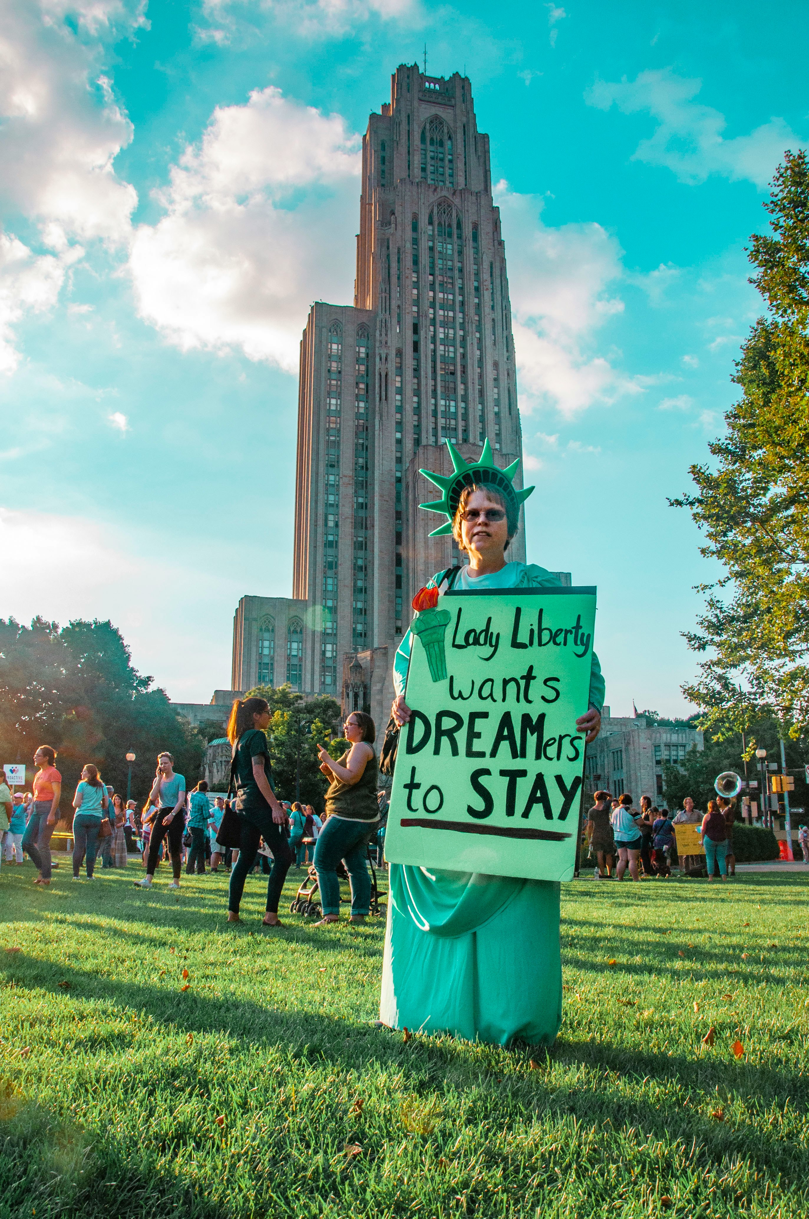 man holding Lady Liberty wants dreamers to stay signage